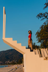 Side view of man against clear blue sky