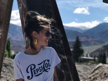 Smiling woman standing on mountain