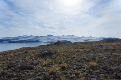 Scenic view of sea and mountains against sky