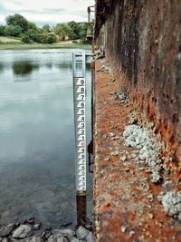 Close-up of metal wall by lake