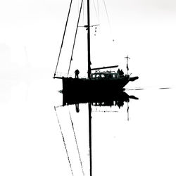 Ship in water against clear sky