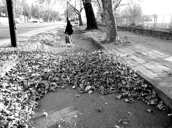 Full length of woman walking on footpath