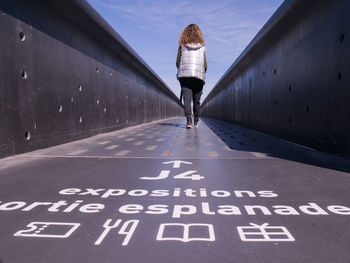 Rear view of woman on bridge