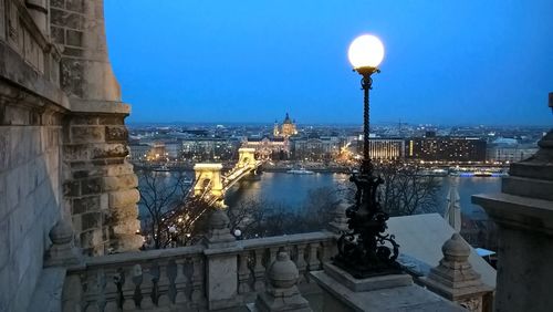 Illuminated city against sky