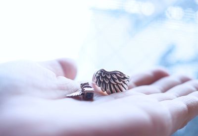 Cropped image of hand holding ring