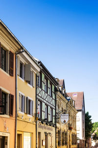 Low angle view of buildings against blue sky