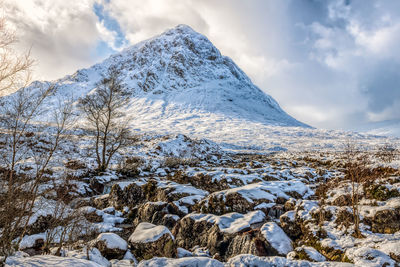 Scenic view of snow covered mountains against sky