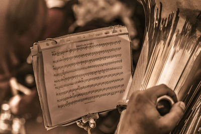 Close-up of hand holding open book