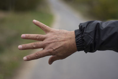 Close-up of person hand with text against blurred background