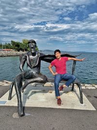 Full length of men in sea against sky