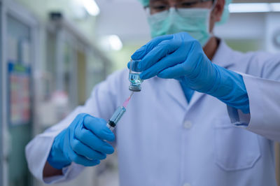 Midsection of person holding umbrella