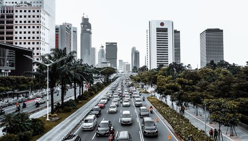 View of city street and buildings against sky