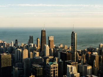 Aerial view of modern buildings in city against sky