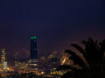 Illuminated cityscape against sky at night