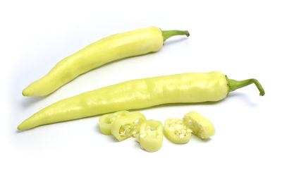 Close-up of green chili pepper against white background