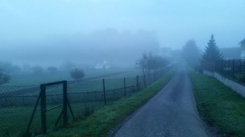 Scenic view of field against sky during foggy weather