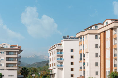 Turkish apartment buildings against the backdrop of a mountain range in alanya.