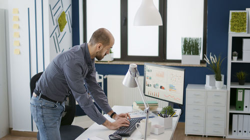 Side view of business colleagues working at office