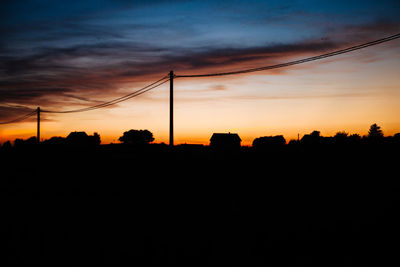 Silhouette landscape against sky during sunset