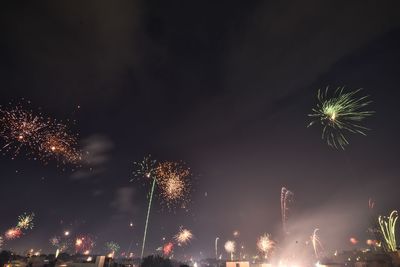 Low angle view of firework display at night