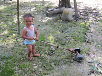 Full length of boy standing on field