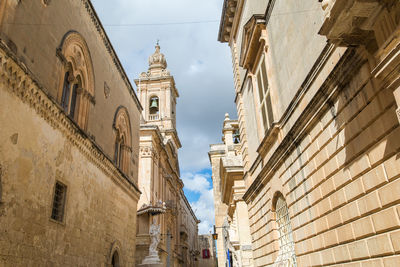 Low angle view of buildings in city against sky