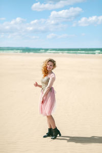 Full length of woman standing on beach