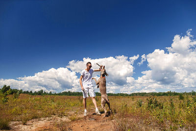 Man standing on field against sky