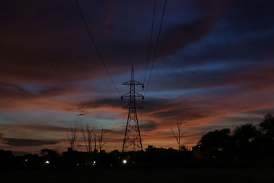 Sky of blue and orange tint with a tower standing in middle of the frame