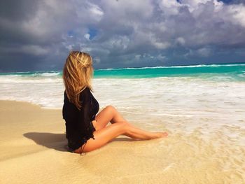 Rear view of woman standing on beach