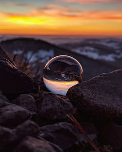 Close-up of rocks on shore during sunset