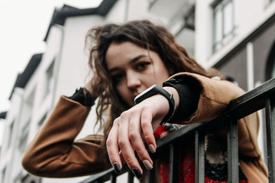 Portrait of young woman holding camera