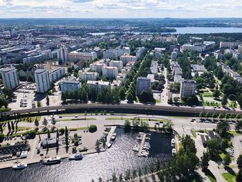 High angle view of city by river against sky