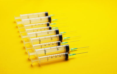 Close-up of yellow pencils over white background