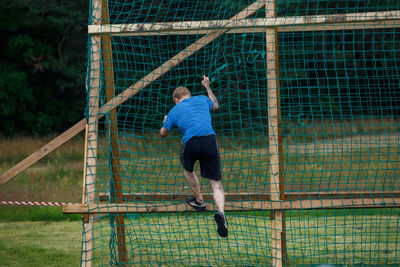 Full length rear view of man jumping