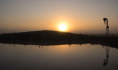 Scenic view of lake against sky during sunset