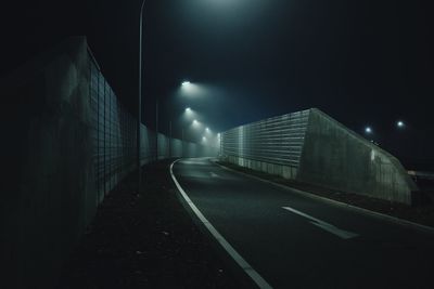 View of illuminated tunnel at night