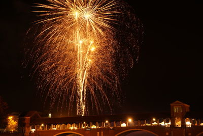 Low angle view of firework display at night