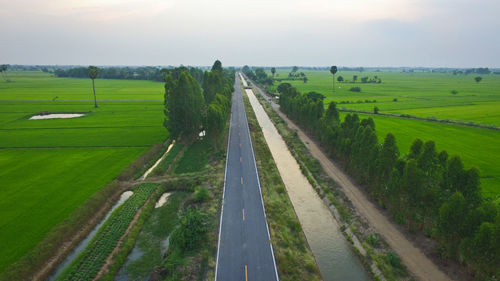 Panoramic view of agricultural field against sky