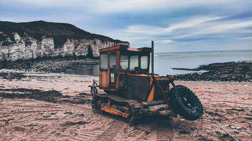 Abandoned vehicle on beach