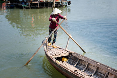 High angle view of man working in lake