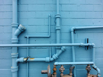 Full frame shot of pipes against blue wall