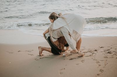 Rear view of woman on beach