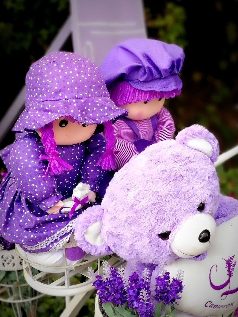 CLOSE-UP OF PURPLE FLOWERS WITH TOYS