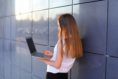 Rear view of woman using mobile phone