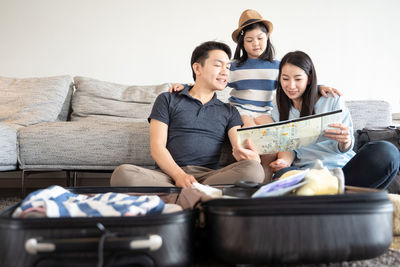 Young couple sitting on sofa at home