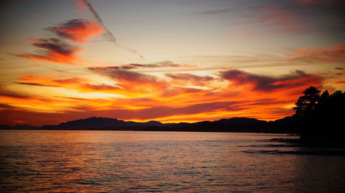 Scenic view of sea against romantic sky at sunset