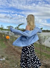 Rear view of woman looking at camera