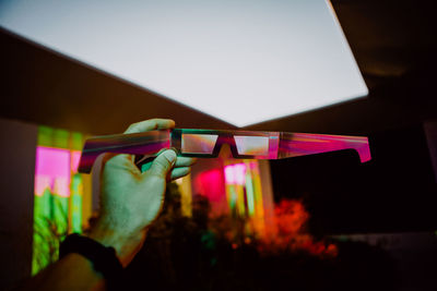 Close-up of hand holding illuminated lights at home