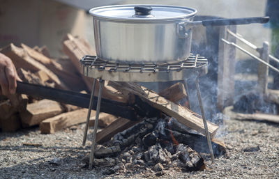 Cropped image of person cooking at campsite